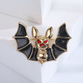 Black Wing Bat Brooch with Gold Tone Body and Red Eyes view 3