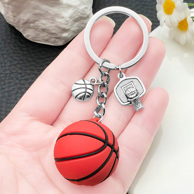 Front display of red basketball PVC keychain with hoop charms with visible colors and attached hardware