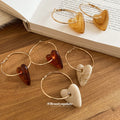 Gold Tone Hoop Earrings with Resin Heart Drops in Three Colors view 4