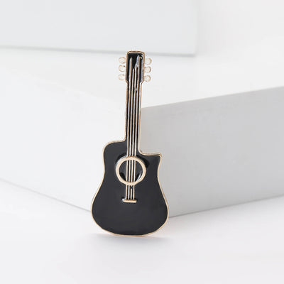 Front view of a black acoustic guitar with gold-tone trim and a clear center stone