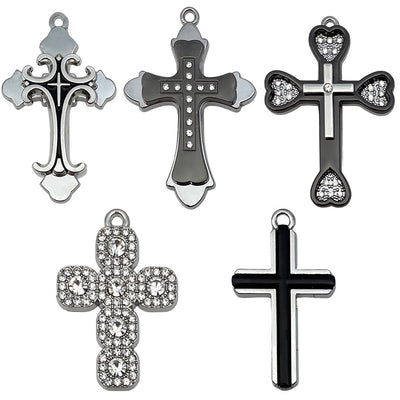 Metallic cross charms arranged on a light background