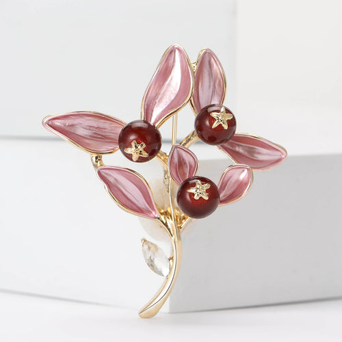 Close-up product view showing the colors and surface details of the enamel leaf branch brooch