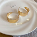 Wide Polished C Hoop Earrings in Gold and Silver Tone Finishes view 6