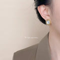 Gold Oval Shell Stud Earrings Twisted Rope Frame Border view 2