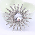 Radiant Sunburst Brooch With A Large Clear Center Stone Surrounded By Long Crystal Rays view 7