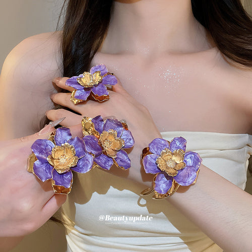 Model wearing purple enamel flower ring cuff and earring set