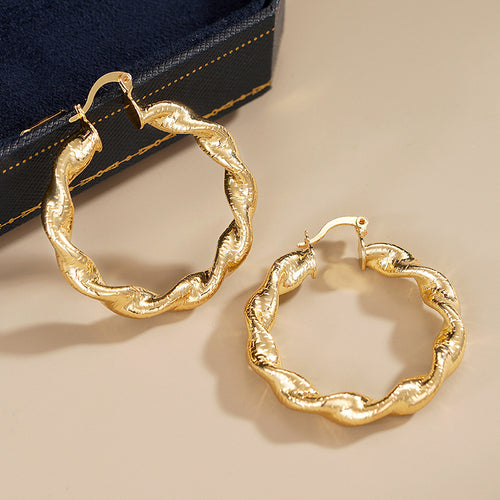 Alternate close view of the gold tone earrings