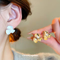 Sculpted Flower Stud Earrings in Gold Tone and White view 2