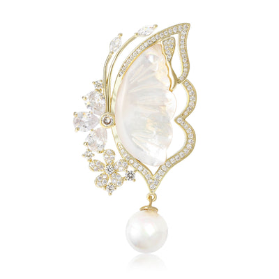 Front view of shell effect butterfly pearl drop brooch against a white background.