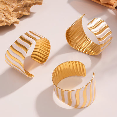 On-wrist view of broad wavy open cuff bracelet in main image 1.