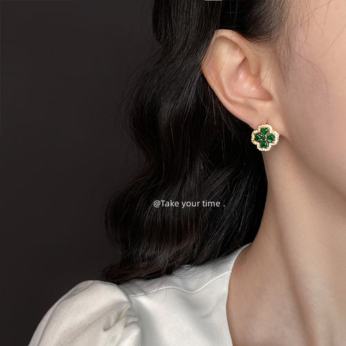 Emerald clover pave stud worn on model ear with dark hair