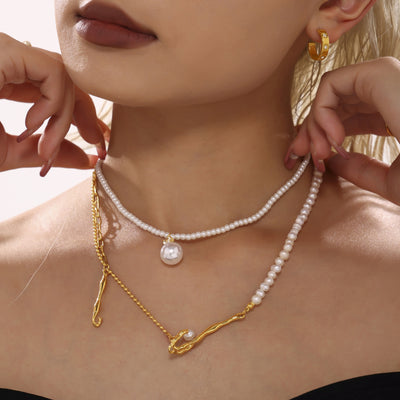 Asymmetric gold freshwater pearl organic twist necklace layered with pearl choker