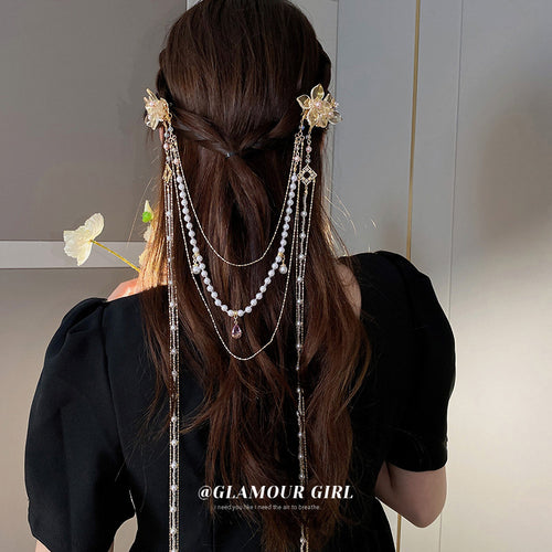 gold-tone floral hair clip with long pearl and chain drapes shown in the first close product view