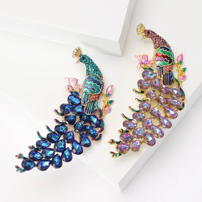 Front view showing the antique gold peacock brooch with colorful enamel crystal tail