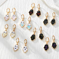 Gold Tone Pressed Flower Hamsa Huggie Earrings in Nine Options view 1