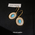 Blue Round Stone Drop Earrings with White Halo and Gold Tone Hooks view 4