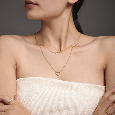 Model wearing gold double-layer open heart zircon necklace