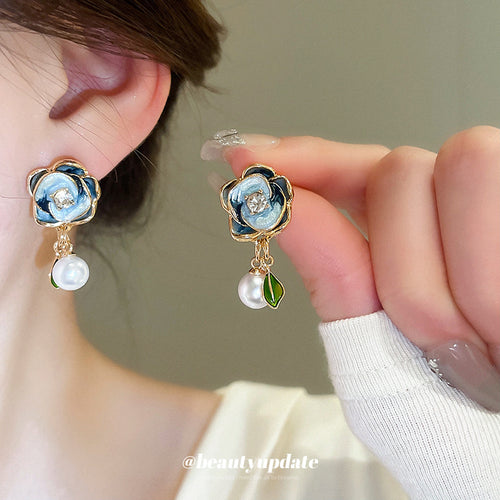 blue rose floral stud earrings shown in a clear product view