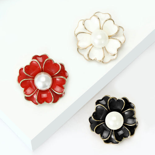 Red white and black peony pearl enamel brooches on white display