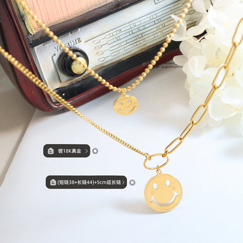 Gold layered smiley necklace flat lay with size and plating labels