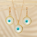 Gold Tone Round Pearl Blue Evil Eye Pendant Necklace and Earrings view 1
