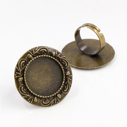 Grouped detail view of ornate round adjustable ring settings in antique bronze and silver tones