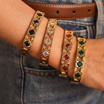 Four gold hinge bangles black white red green square stones on wrist