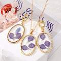 Gold Tone Oval Purple Petal Resin Pendant Necklace and Drop Earrings view 1