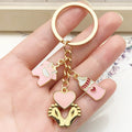 Eight Pink Baby Bottle Outfit and Footprint Keychain Designs view 1