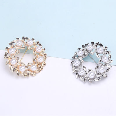 Front view of the pearl and crystal floral wreath brooch decorative clothing pin on a white background