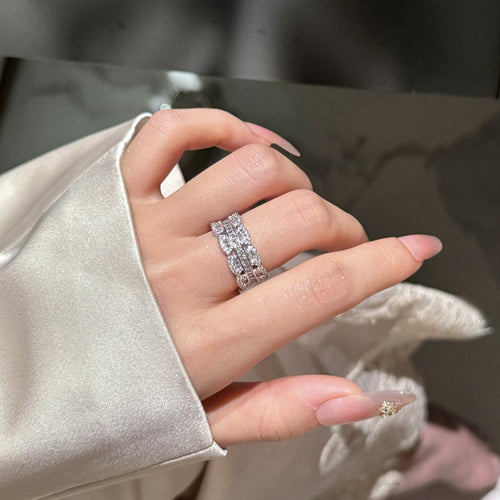 Silver multi-row crystal open ring worn on ring finger