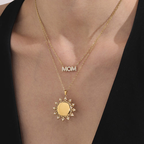 Display view of sunburst and MOM crystal necklaces in main image 2.