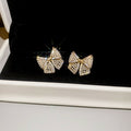 Gold Tone Crystal Bow Stud Earrings With Small Pearl Details view 6