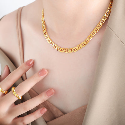 Model wearing thick gold mariner link chain choker necklace