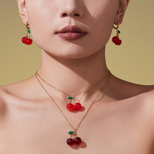 Display view of red cherry pendant necklaces and hoop earrings in main image 2.