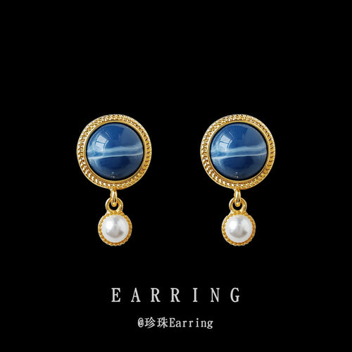 Blue cabochon pearl drop studs on black background