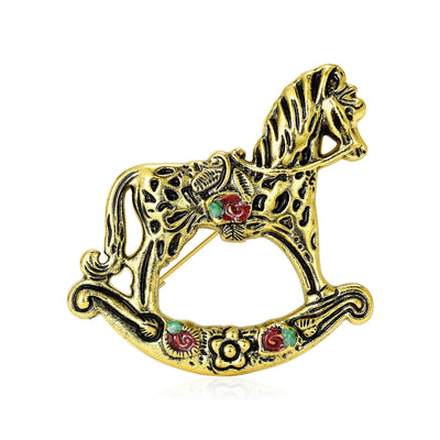 Main front view of Antique Gold Tone Rocking Horse Brooch With Red Details