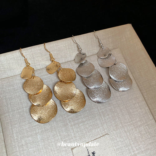 Layered Sequin Disc Drop earrings shown worn at the ear