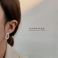 Asymmetric Hollow Cream Glaze Stud Earrings Dark Oval Pair view 2