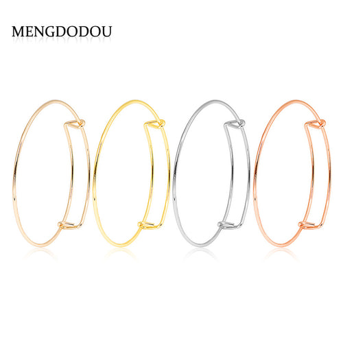 Four expandable wire bangles in light gold gold silver and rose gold