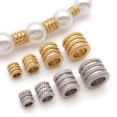 Metallic spacer bead beads arranged on a light background
