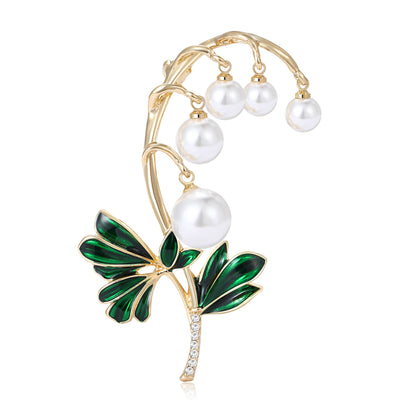 Grouped view of lily-of-the-valley brooch with five pearl-like bell flowers arranged together.