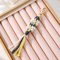 Gold Tone Woven Daisy Tassel Clip Keychains in Two Colorways view 3