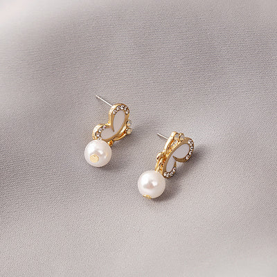 Supplied main image of butterfly pearl-look huggie earrings