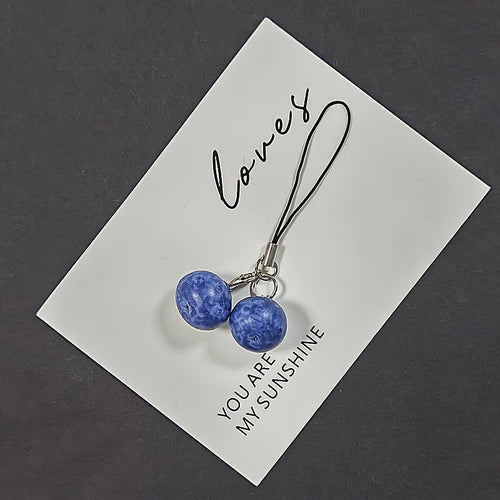 Twin resin blueberry phone charm on white card