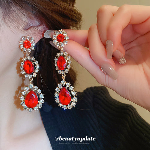 red teardrop crystal halo short drop statement earrings displayed from a second angle