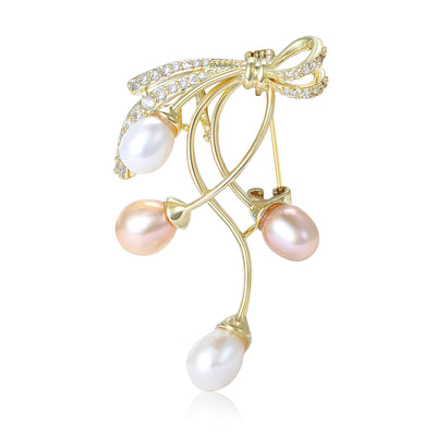 Front view of pink white pearl branch brooch against a white background.