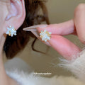 White Flower Star Stud Earrings with Crystal Gold Tone Details view 1