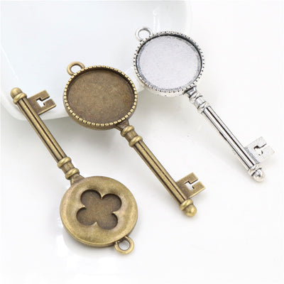 Key Shaped Round Cabochon Pendant Bases in Bronze and Silver shown with the available finish assortment