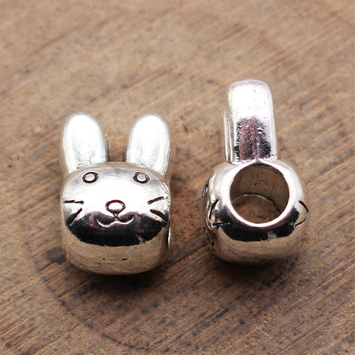 Double Sided Rabbit Head Large Hole Bead displayed on a natural textured background